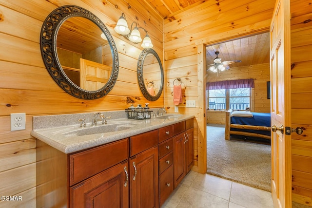 ensuite bathroom featuring ensuite bath, wood walls, wood ceiling, and a sink