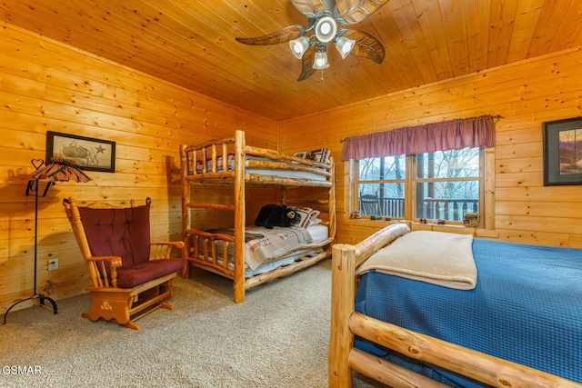 carpeted bedroom featuring wood ceiling and wood walls