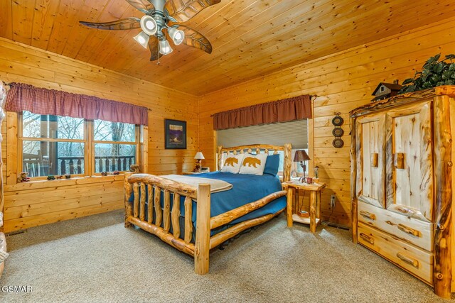 bedroom with ceiling fan, wooden ceiling, carpet flooring, and wooden walls