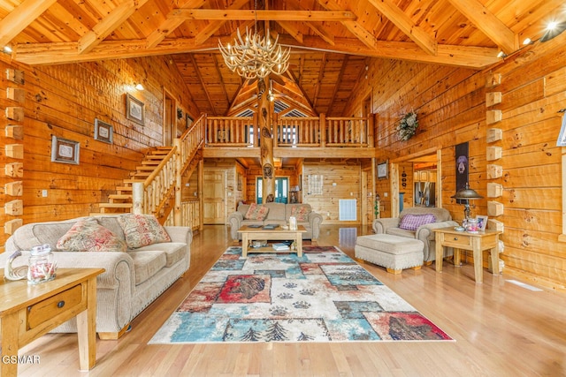 living room featuring wooden ceiling, a chandelier, and wood walls