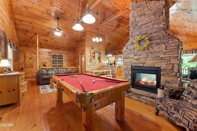 game room with wood ceiling, light wood finished floors, a stone fireplace, high vaulted ceiling, and billiards table
