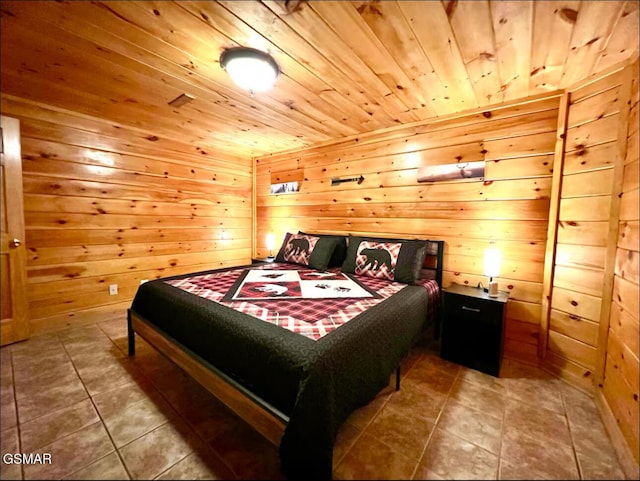 bedroom with wood ceiling, tile patterned floors, and wooden walls