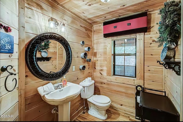 bathroom with wooden ceiling, wooden walls, wood finished floors, and toilet