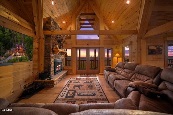 living room featuring wood ceiling, french doors, beam ceiling, wood finished floors, and high vaulted ceiling