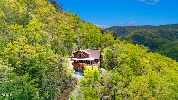 drone / aerial view featuring a wooded view
