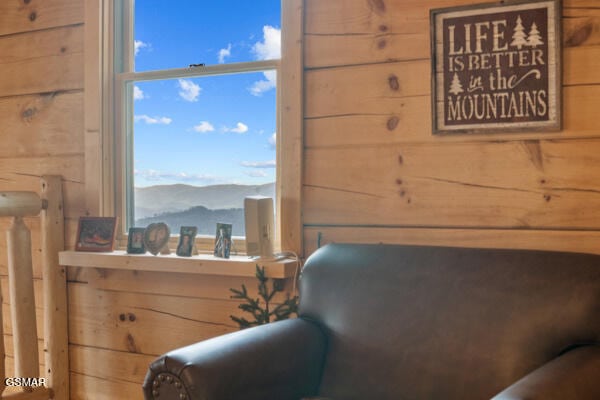 bedroom featuring wood walls and a mountain view
