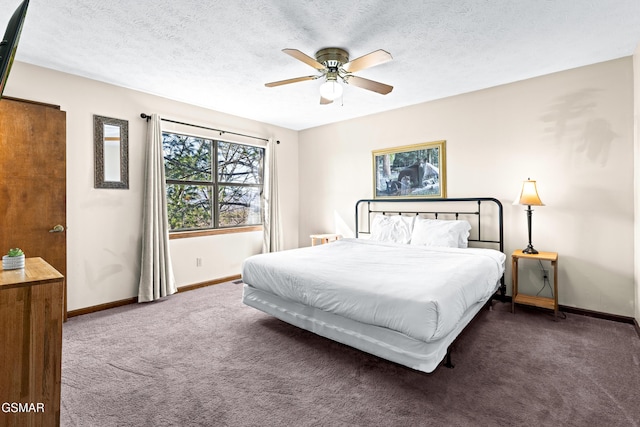 bedroom featuring a textured ceiling, ceiling fan, and dark colored carpet