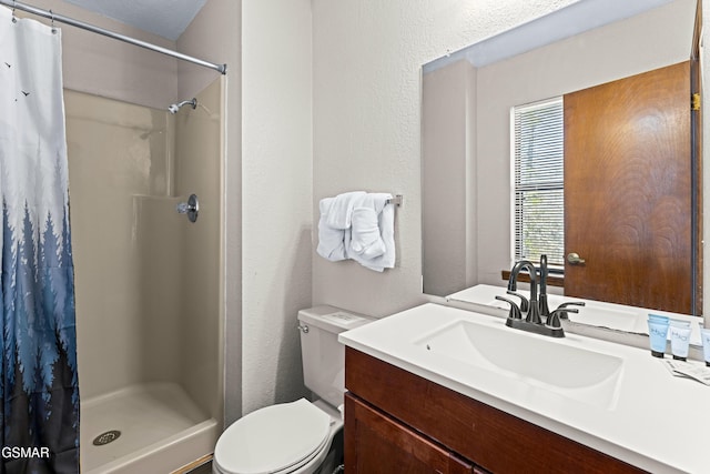 bathroom featuring toilet, vanity, and a shower with shower curtain