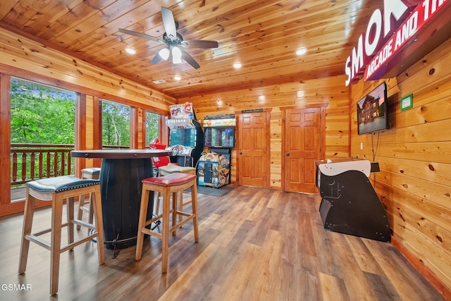 interior space with wood walls, ceiling fan, light wood-type flooring, recessed lighting, and wood ceiling