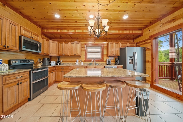 kitchen featuring a sink, wood ceiling, appliances with stainless steel finishes, and light tile patterned floors