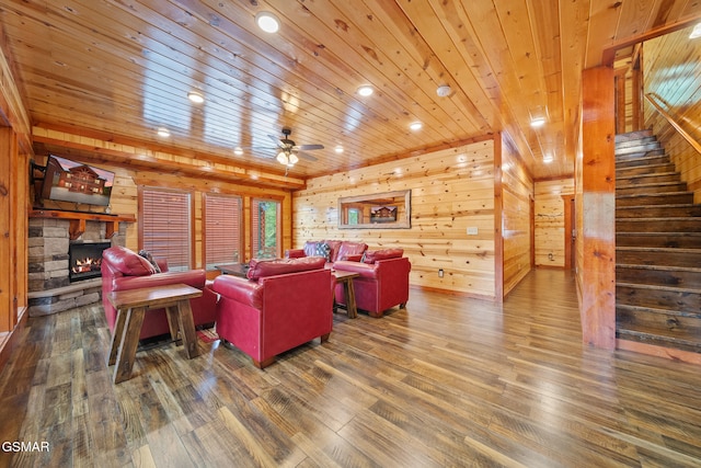 living room featuring wood ceiling, wood finished floors, wooden walls, and a fireplace