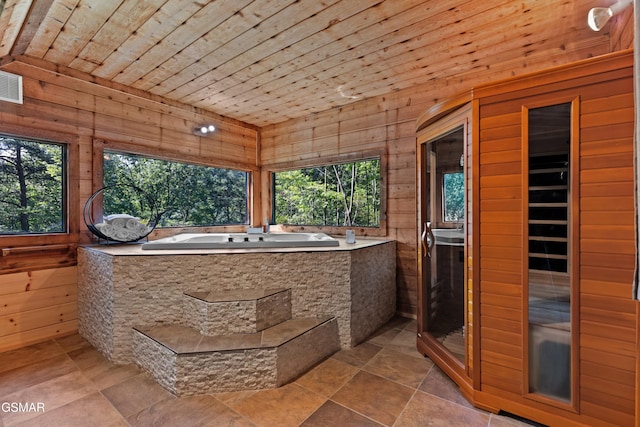 bathroom featuring a bath, wooden ceiling, and wood walls