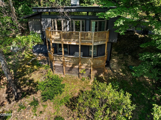 rear view of property with a wooden deck