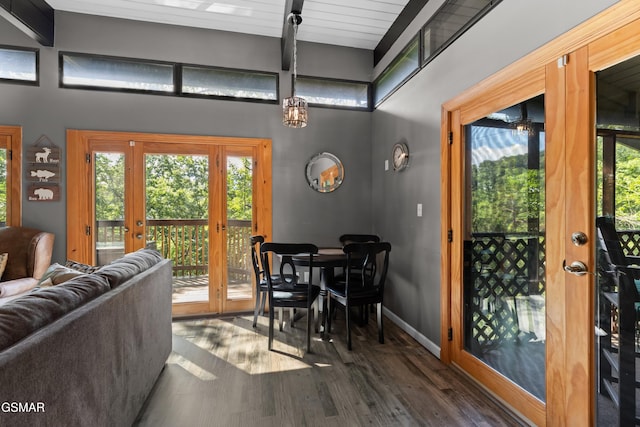 interior space with a towering ceiling, dark wood-type flooring, and french doors