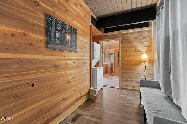 hallway featuring hardwood / wood-style floors, wood ceiling, and wood walls