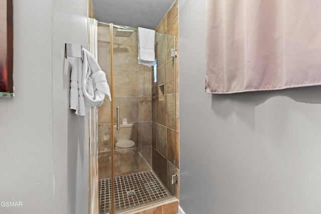 bathroom featuring a shower with shower door