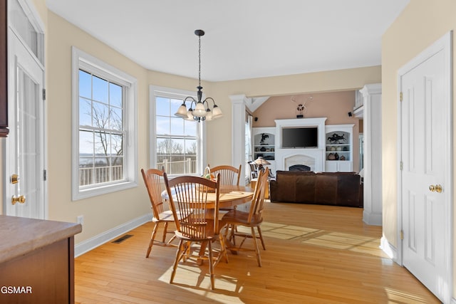 dining room with a notable chandelier and light wood-type flooring