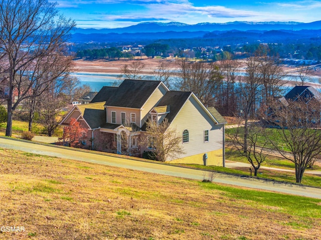 exterior space featuring a mountain view and a front lawn