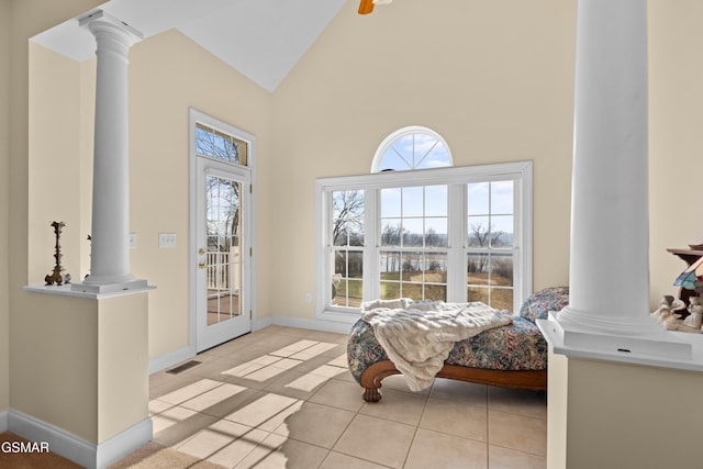 interior space featuring light tile patterned flooring and high vaulted ceiling