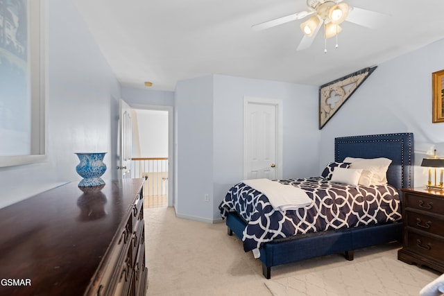 bedroom featuring ceiling fan and light carpet