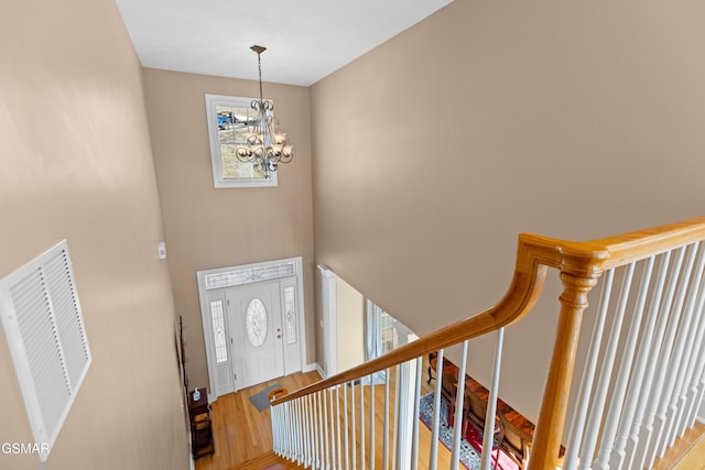 foyer featuring hardwood / wood-style floors and an inviting chandelier