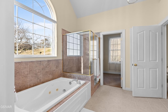 bathroom with tile patterned flooring, lofted ceiling, and independent shower and bath