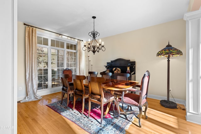 dining room featuring hardwood / wood-style flooring and a notable chandelier