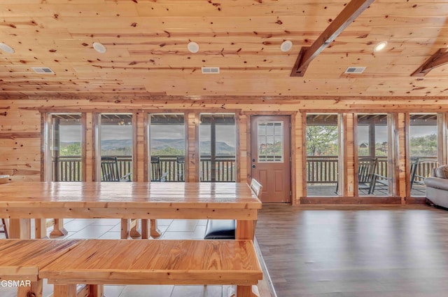 unfurnished dining area with visible vents, wood ceiling, vaulted ceiling with beams, and wood finished floors
