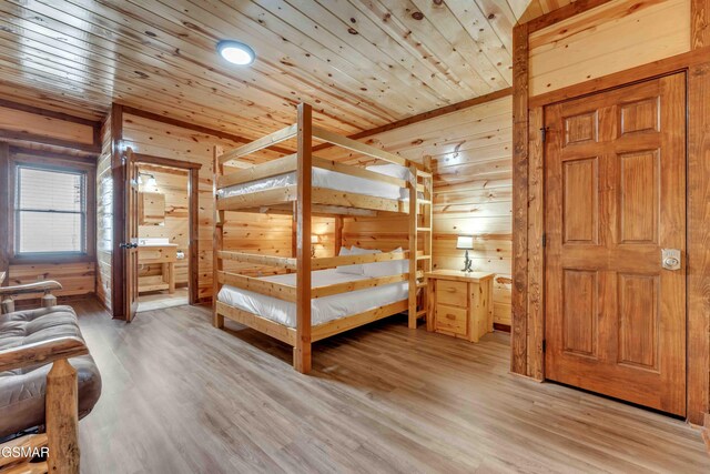 bedroom with wood walls, light wood-type flooring, and wooden ceiling