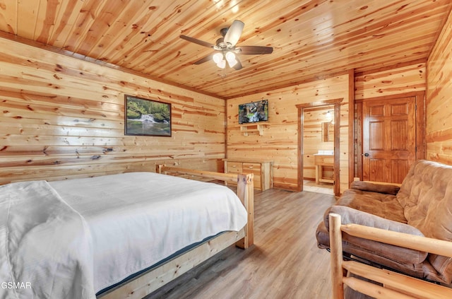 bedroom featuring wooden walls, connected bathroom, wood finished floors, and wood ceiling