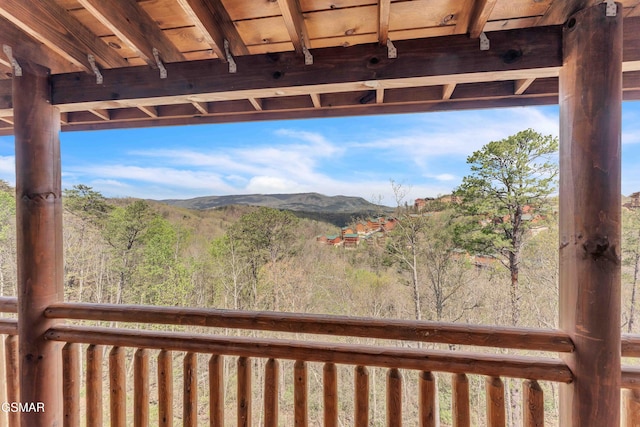exterior space with a wooded view and a mountain view