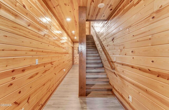 stairway featuring wood walls, recessed lighting, wood finished floors, and wood ceiling