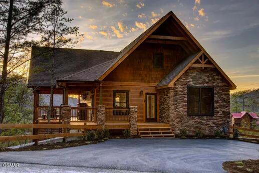 view of front of house with stone siding and a porch