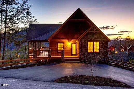 log-style house featuring fence