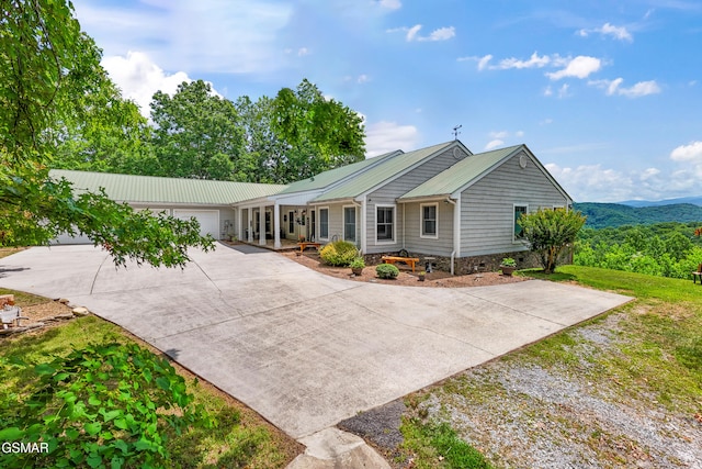 single story home featuring a mountain view, a garage, and a front yard