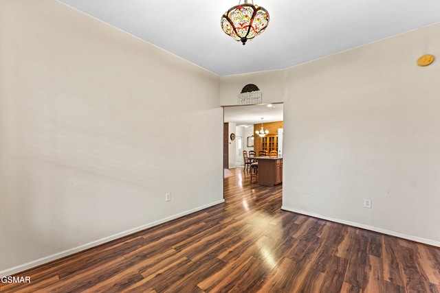 3351 Line Springs Rd, Sevierville, TN 37862 - unfurnished room with a chandelier, dark wood-style floors, baseboards, and a smoke detector