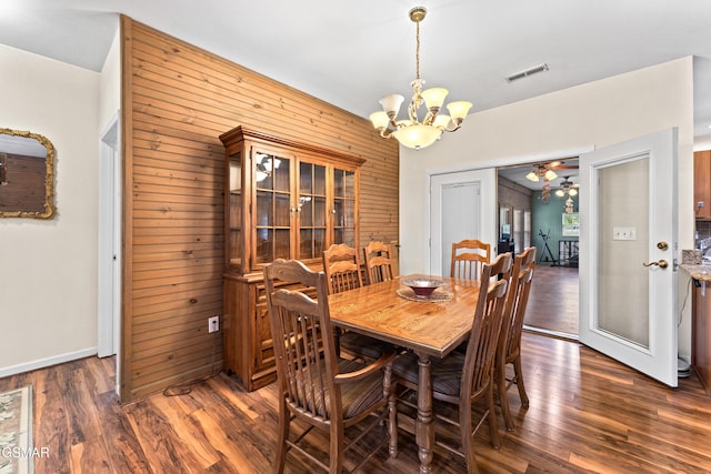 3351 Line Springs Rd, Sevierville, TN 37862 - dining area featuring wood walls, a chandelier, dark wood-style floors, ceiling fan, and baseboards