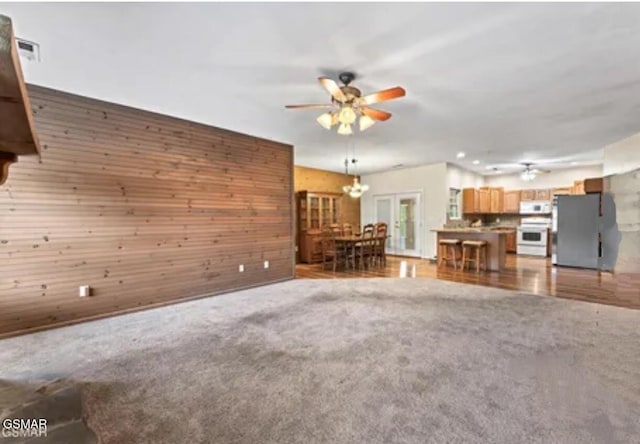 3351 Line Springs Rd, Sevierville, TN 37862 - living room featuring a ceiling fan, wood walls, and light colored carpet