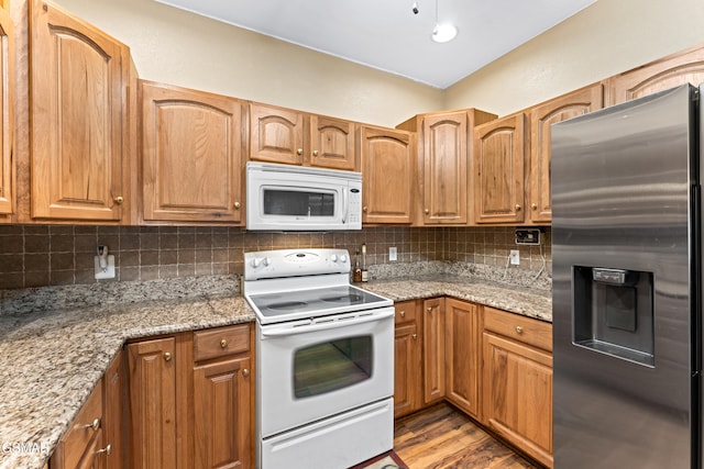 3351 Line Springs Rd, Sevierville, TN 37862 - kitchen featuring white appliances, tasteful backsplash, light stone countertops, and wood finished floors