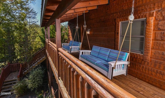 wooden terrace featuring an outdoor hangout area and stairs