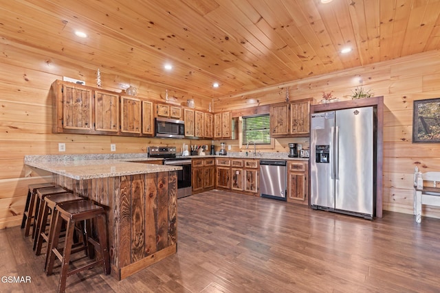 3181 Thomas Headrick Rd, Sevierville, TN 37862 - kitchen with stainless steel appliances, a peninsula, dark wood-style flooring, wooden ceiling, and brown cabinets