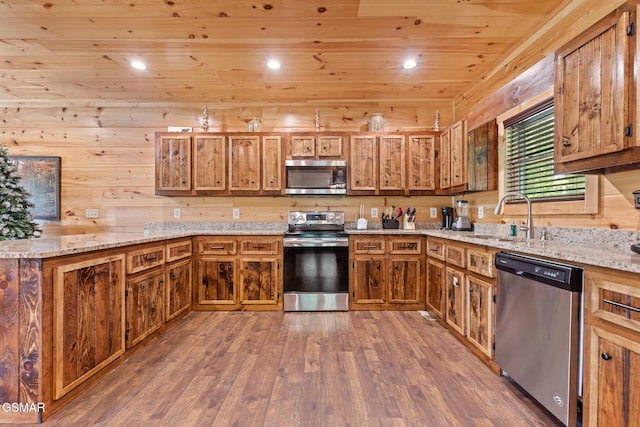 3181 Thomas Headrick Rd, Sevierville, TN 37862 - kitchen featuring stainless steel appliances, wood ceiling, brown cabinetry, wood finished floors, and a peninsula