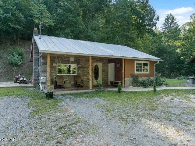 view of front facade with metal roof and stone siding