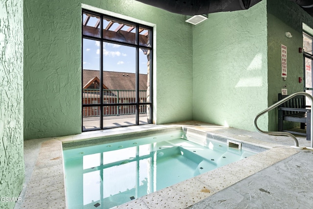 view of swimming pool featuring an indoor hot tub