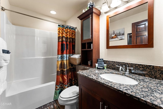 bathroom featuring toilet, vanity, and shower / bath combo