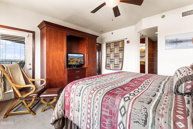 carpeted bedroom featuring a ceiling fan and visible vents