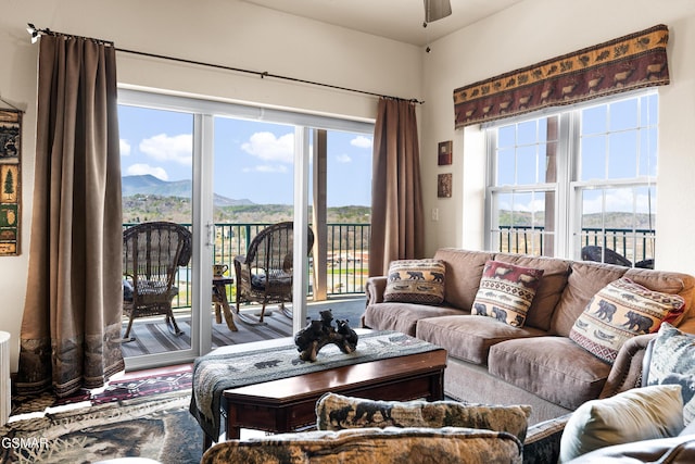 living room with a mountain view and ceiling fan