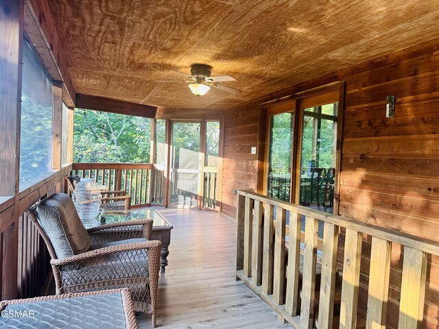 interior space with plenty of natural light, wooden ceiling, and ceiling fan