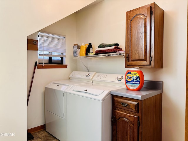 laundry room with washer and dryer and cabinets