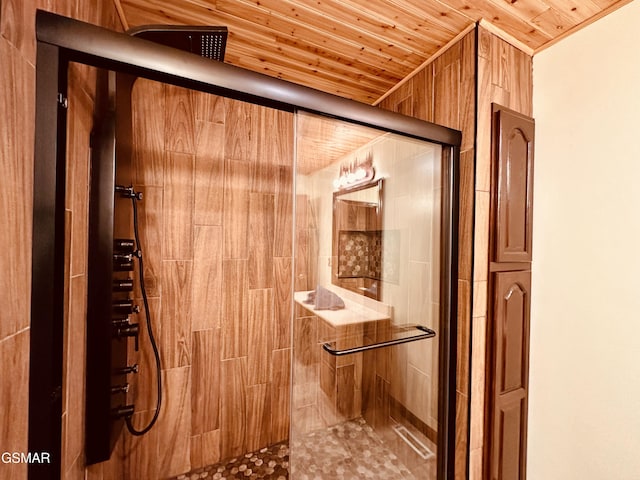 bathroom featuring a shower with shower door and wooden ceiling